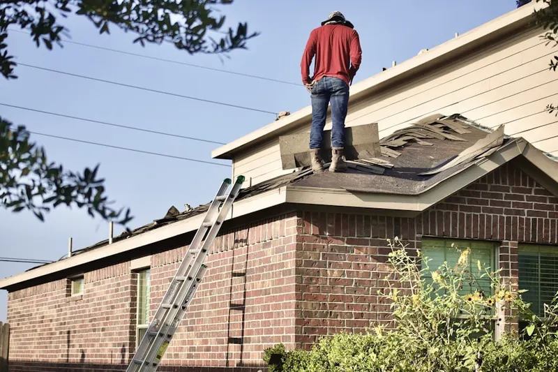 Professional roofer working on a residential roof in Amesbury